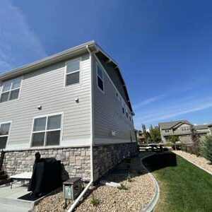Custom Exteriors painting exterior of residential house