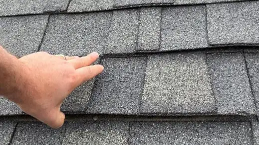 Wind blow shingles - Custom Exteriors, LLC Wind Damaged shingles on Fort Collins roof before being replaced by Custom Exteriors.